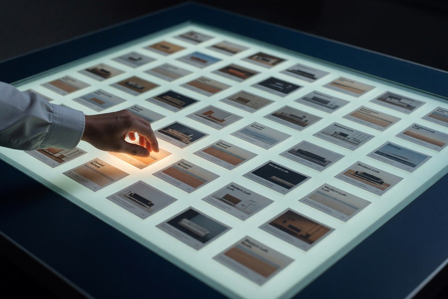 Marketing team reviewing AI-generated ad variations on multiple screens