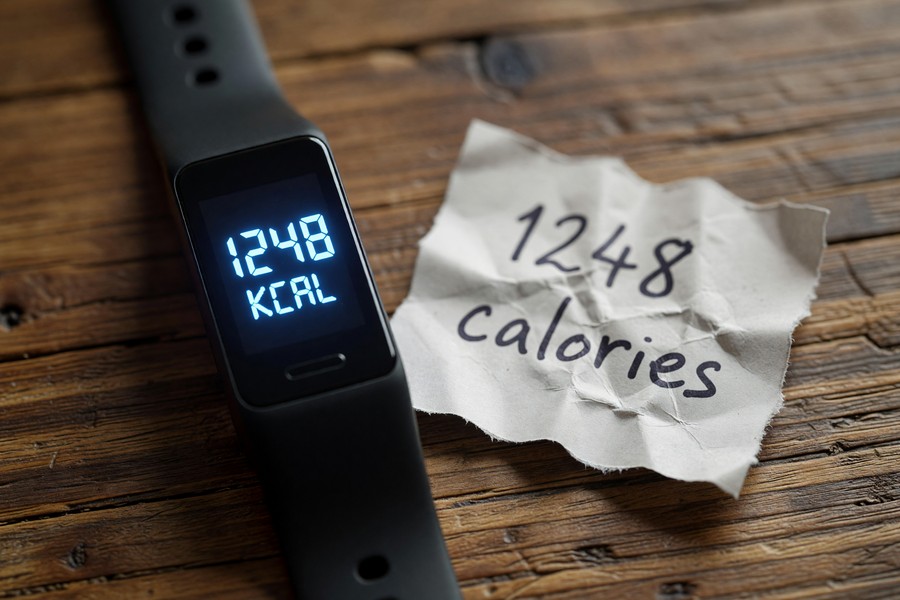 Close-up comparison of three wearable health trackers showing sensor arrays on underside