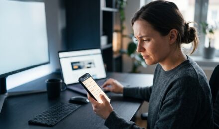 Person using a phone password manager app with a lock icon on screen