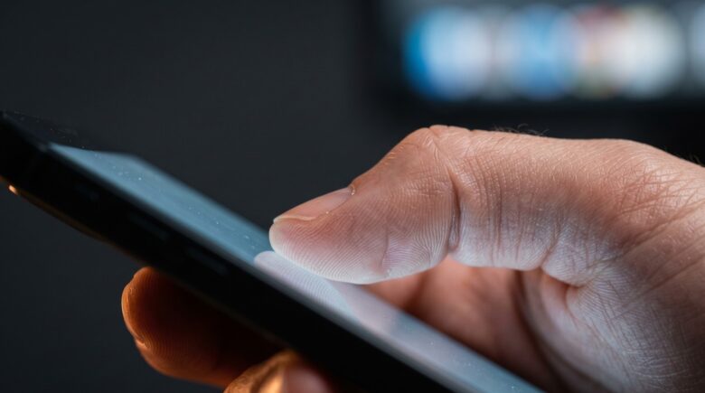 Close-up of a smartphone displaying haptic feedback technology with tactile touch wave effects