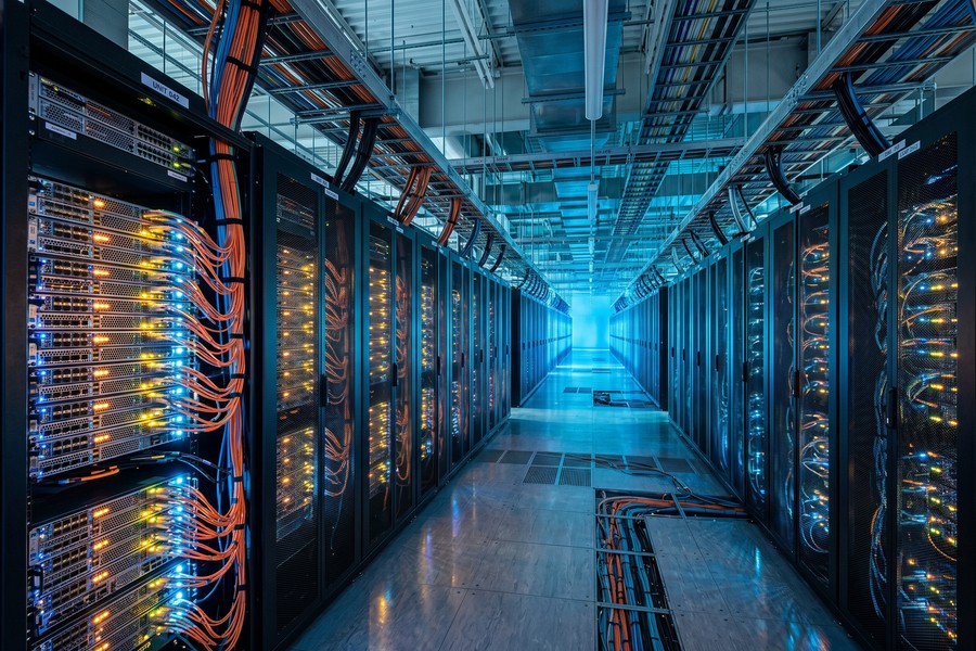 Dense rows of photonic transceiver modules installed in a modern hyperscale data center rack